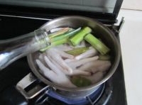 放蔥、姜、料酒和雞腳進去焯燙至變色，用中火續煮；