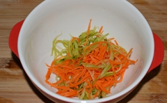 胡蘿蔔和黃瓜用清水沖洗乾淨，用插板插成細絲后，放入碗中；