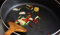 油鍋加熱，放入薑片、蒜片、蔥白、干紅辣椒炒香；