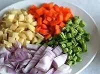 紅蘿蔔和豆角洗凈，切成丁，土豆去皮切丁，洋蔥剝掉外皮，切成丁，放入盤中；
