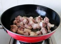 鍋中倒入油燒熱，放入薑片炒出香味，加入鴨塊一起煸炒。