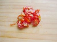 把小番茄洗凈后對半切開備用;