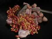 再把泡好的黃豆、紅衣花生米放入翻炒；