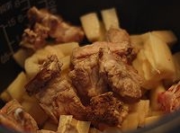 蓮藕塊和排骨塊放在放入電飯煲中，加入薑片，注入適量的水，蓋上蓋煮至；